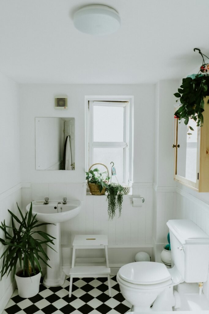 Modern basement bathroom design featuring white tile walls, a glass walk-in shower, and contemporary lighting in a Boston home renovation.
